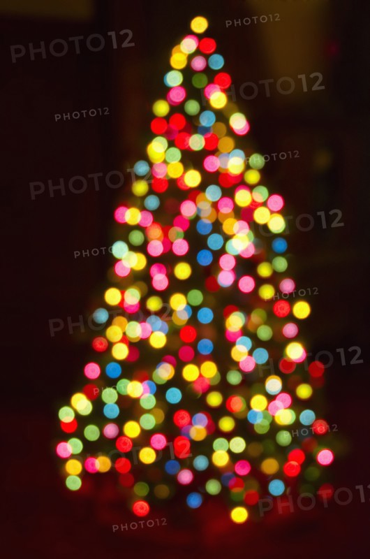 Defocused Christmas tree with colorful lights.