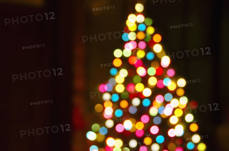 Defocused Christmas tree with colorful lights.