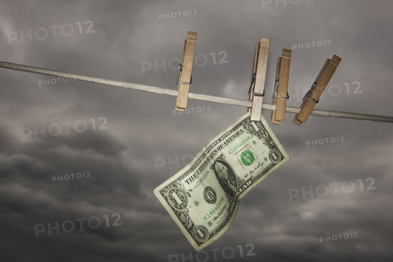 One dollar banknote drying on clothline.