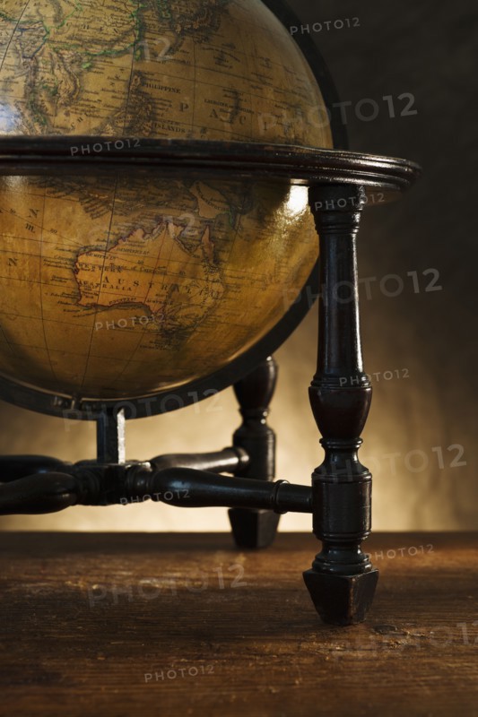 Close up of antique globe on table.