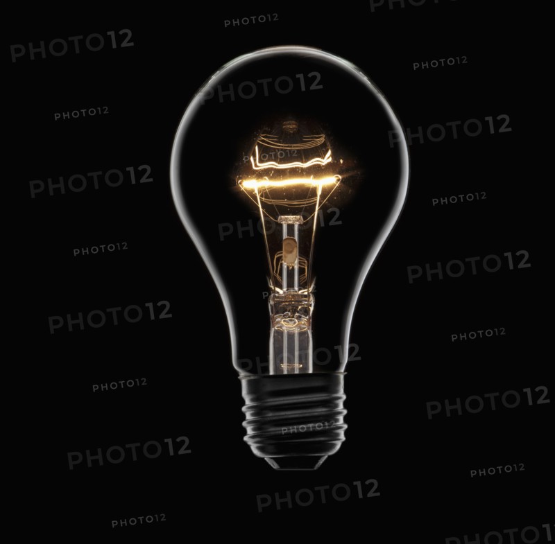 Energy saving bulb on black background, studio shot. Photo : Mike Kemp