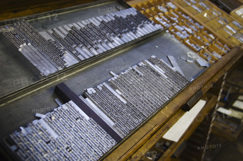 Printing plates on antique printing press.