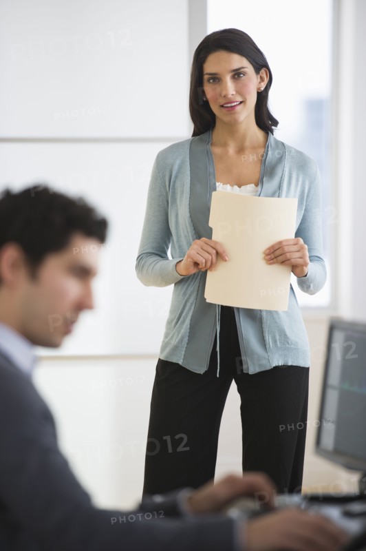 Business man and woman in office.