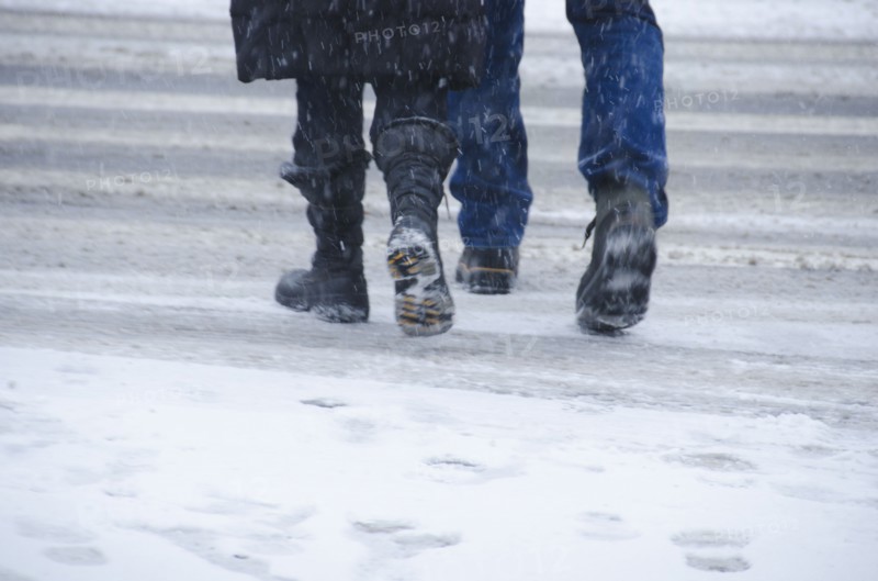 USA, New York City, Pedestrians crossing road in blizzard.