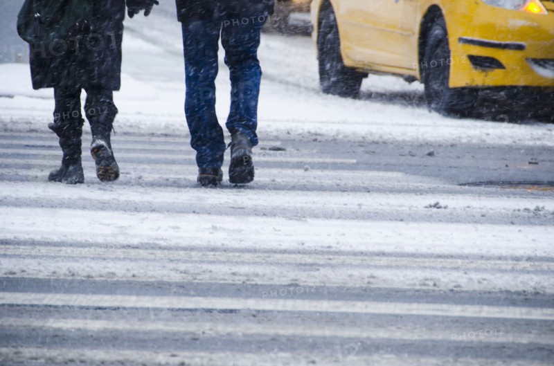 USA, New York City, Pedestrians crossing road in blizzard.