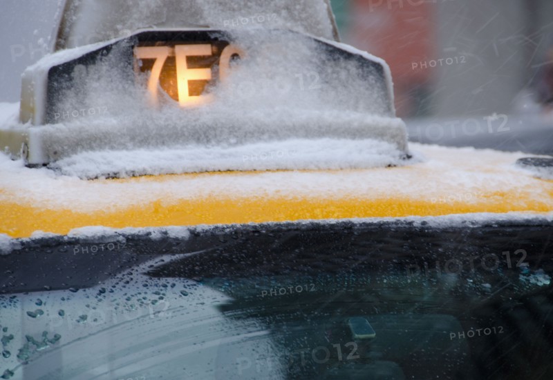 USA, New York City, Taxi roof covered with snow.