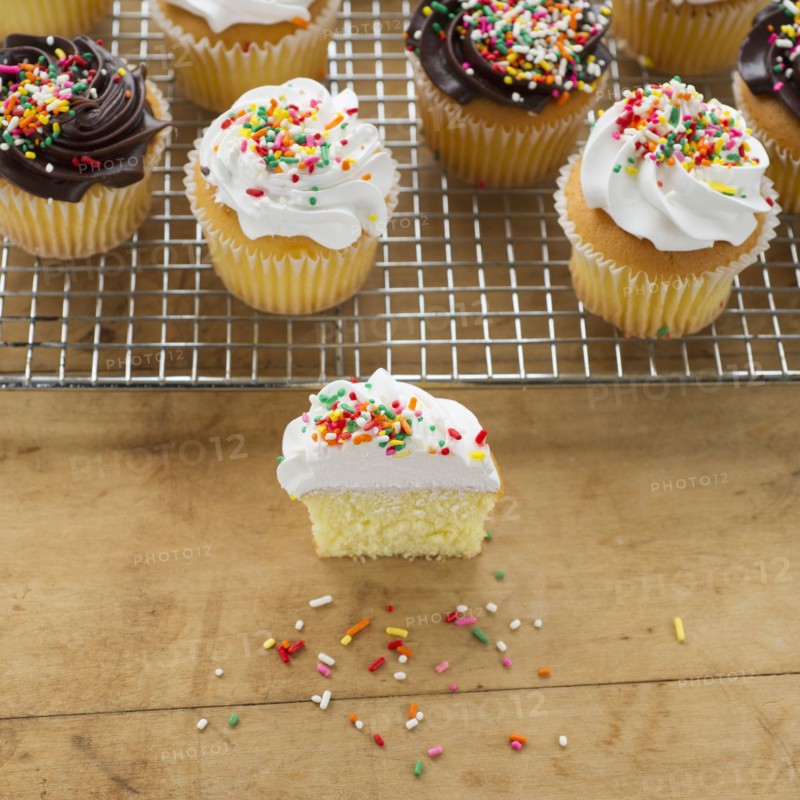 Homemade cupcakes, one with missing bite.