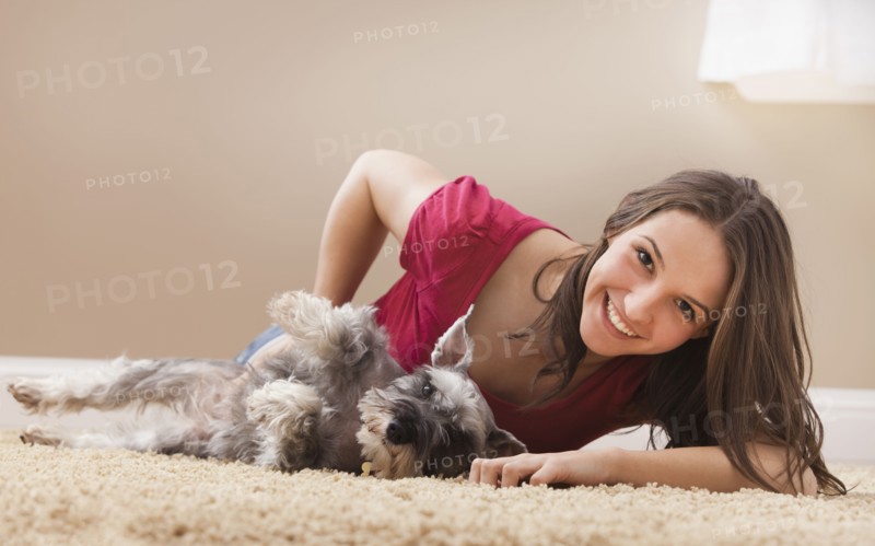 Young woman playing with schnauzer. Photo : Mike Kemp