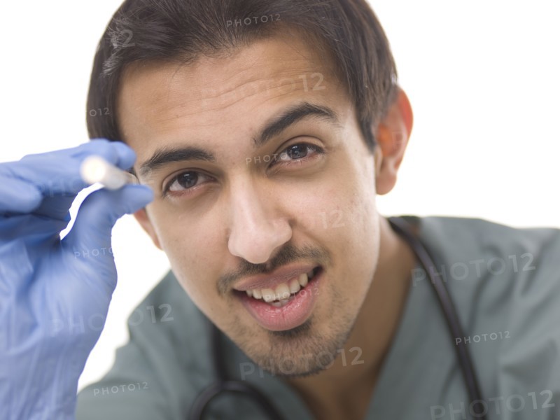 Young surgeon holding small torch. Photo : Dan Bannister