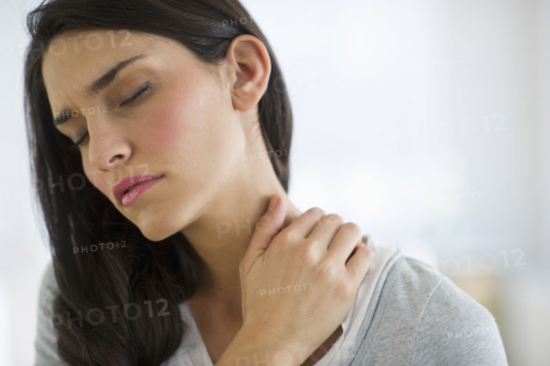 Woman suffering from neck pain.