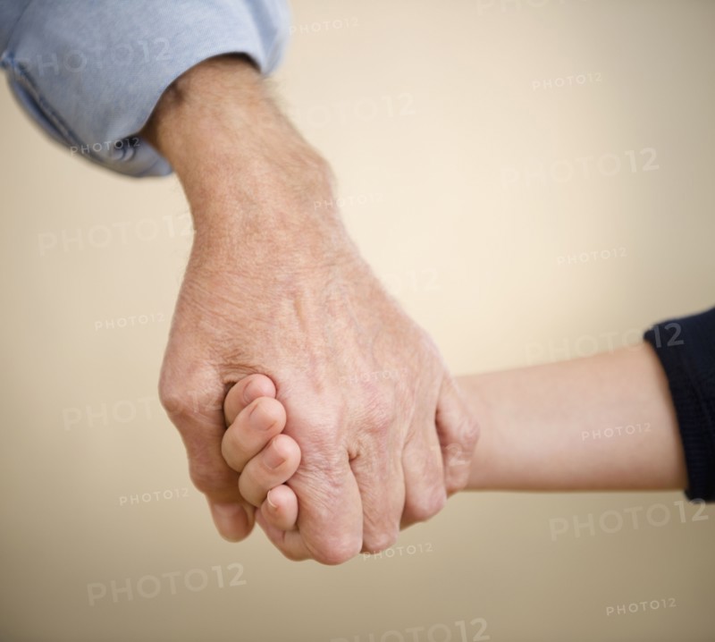 Close up grandfather and grandson (8-9) holding hands. Photo : Jamie Grill Photography