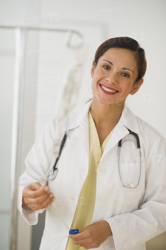 Smiling female doctor with IV drip.