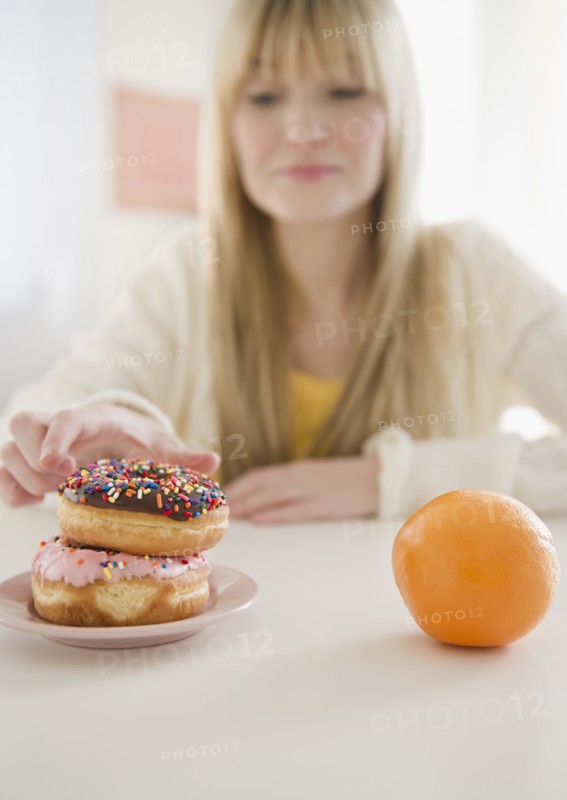 Woman reaching for donut. Photo : Jamie Grill Photography