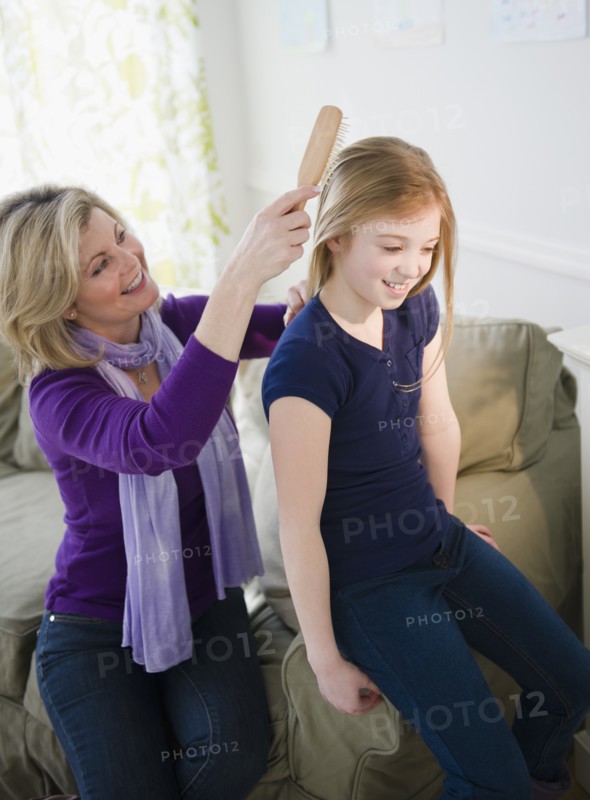Mother brushing daughter's (10-11) hair. Photo: Jamie Grill Photography