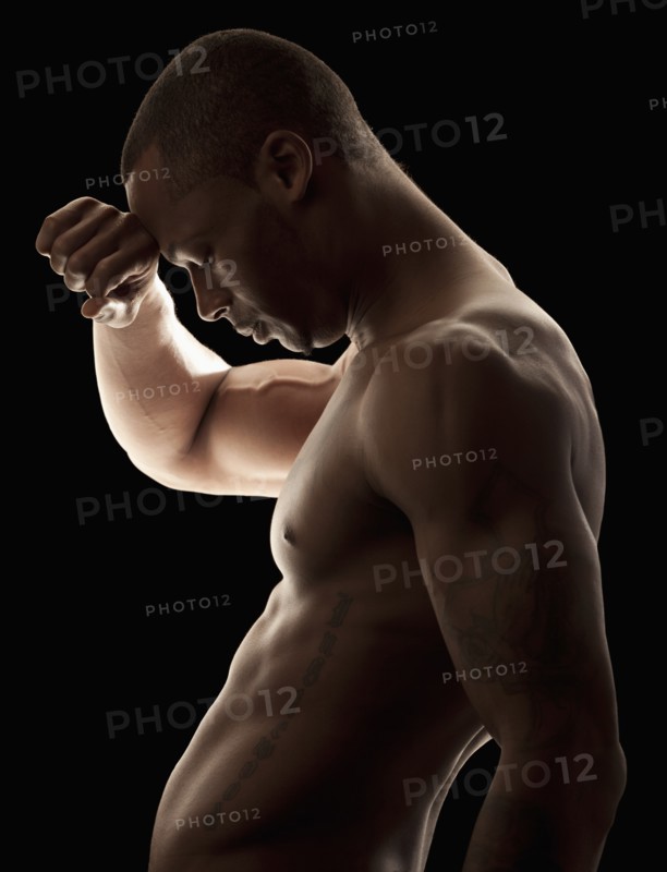 Studio shot of tired shirtless man. Photo: Mike Kemp