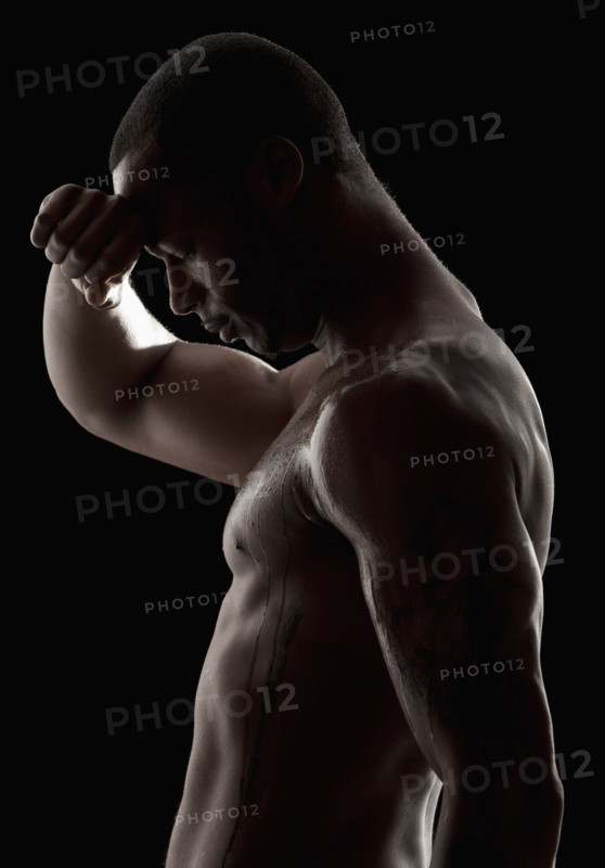 Studio shot of tired shirtless man. Photo: Mike Kemp