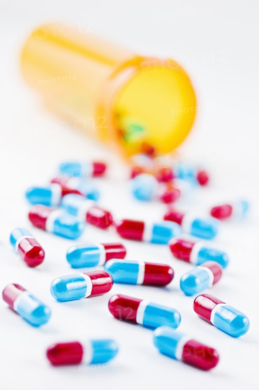 Studio shot of capsules spilling from bottle. Photo: Antonio M. Rosario