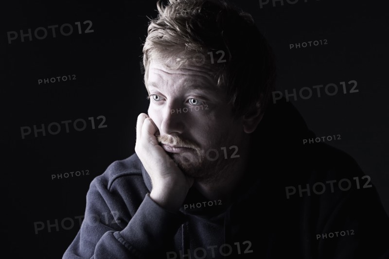 Powerful Low Key Shot of a Sad Red Headed Male