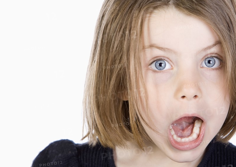 Studio portrait of girl (6-7) with mouth open. Photo: Justin Paget