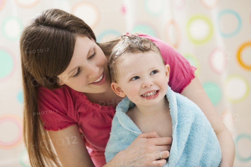 Mother with son (2-3) wrapped in towel. Photo : Mike Kemp
