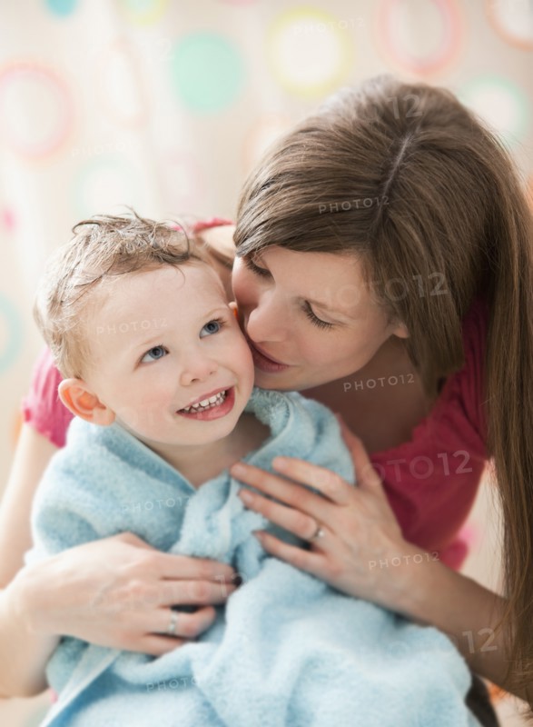 Mother with son (2-3) wrapped in towel. Photo : Mike Kemp