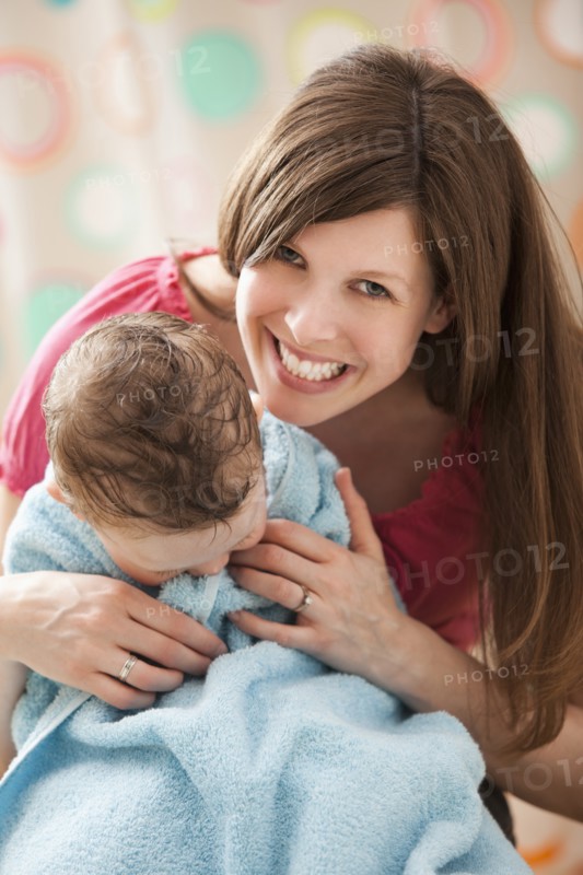 Mother with son (2-3) wrapped in towel. Photo: Mike Kemp