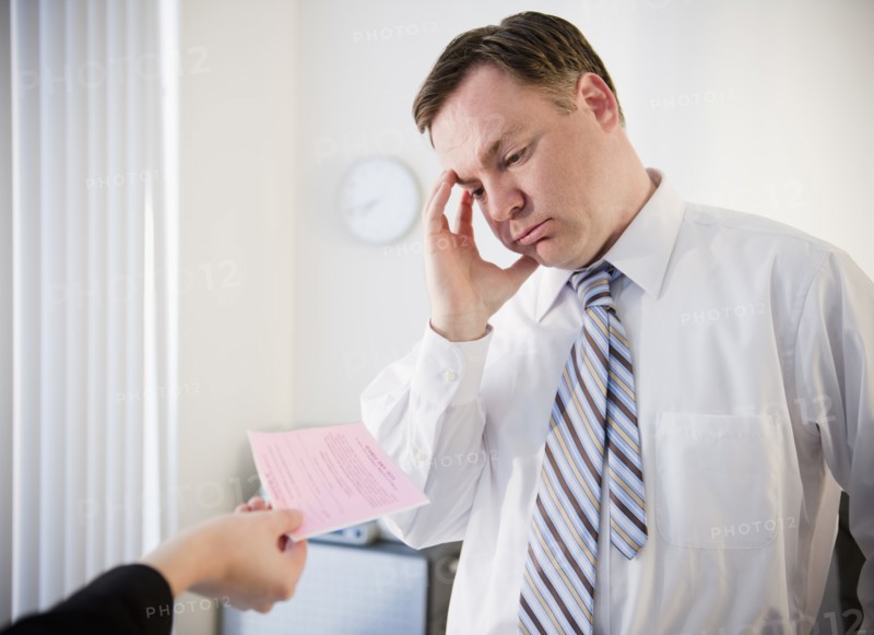 Businessman getting pink slip. Photo: Jamie Grill Photography