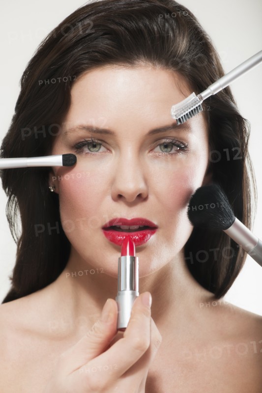 Woman having make up applied.