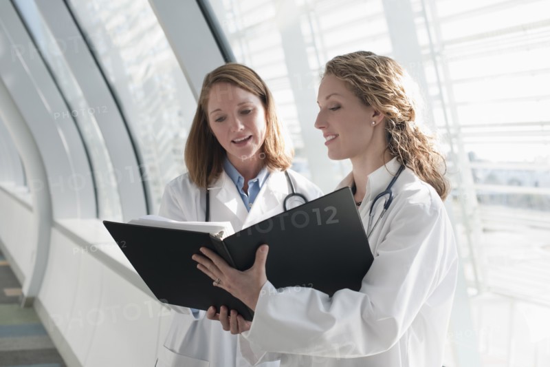 Two female doctors reading record. Photo: Mark Edward Atkinson