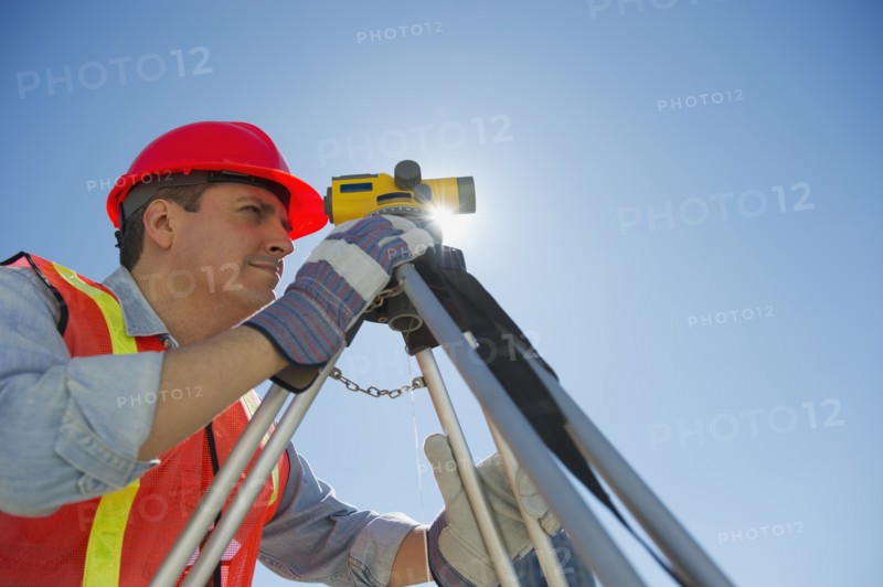 Construction worker against blue sky.