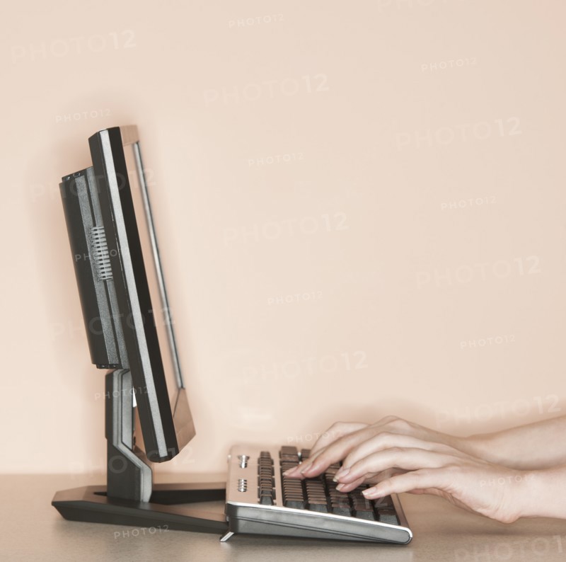 Studio shot of woman working on computer.