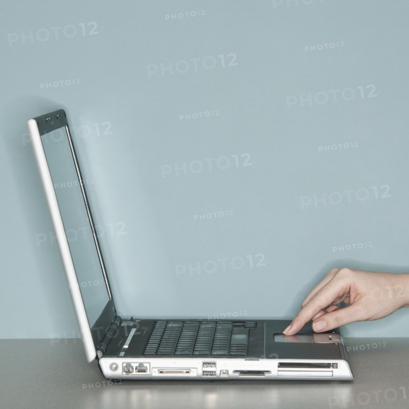 Studio shot of woman working on laptop.