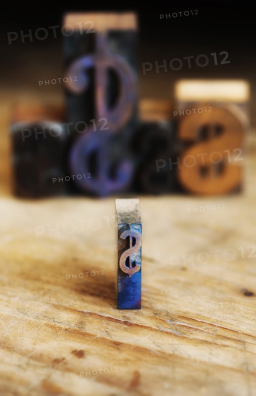 Close up of printing blocks with dollar sign with defocused background.