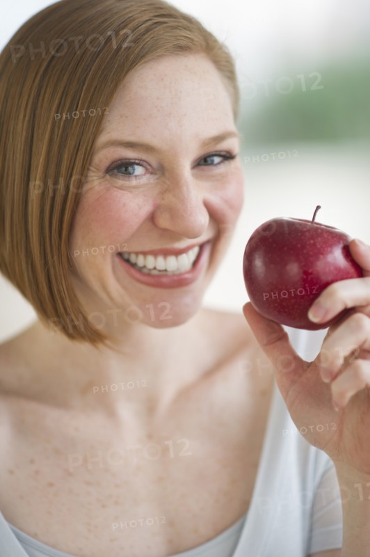 Woman holding fresh apple.