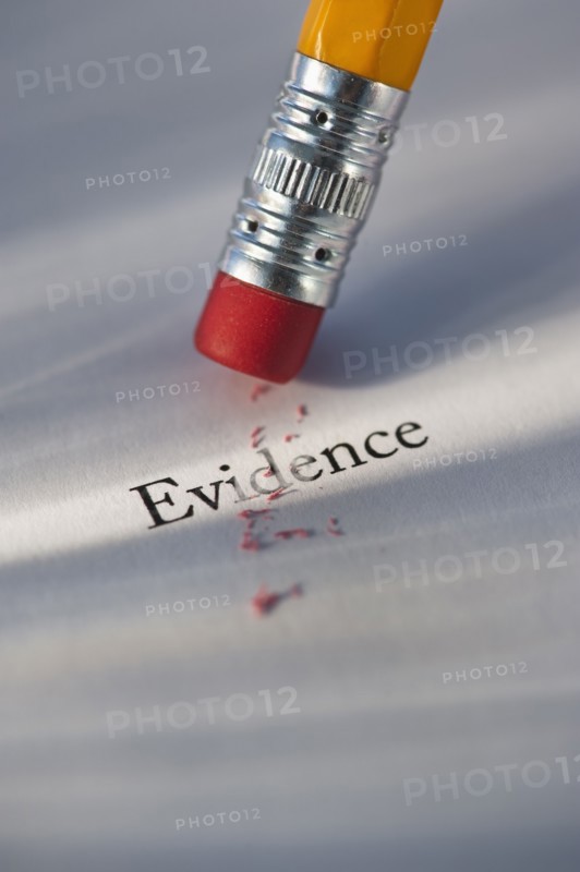 Studio shot of pencil erasing the word evidence from piece of paper. Photo : Daniel Grill