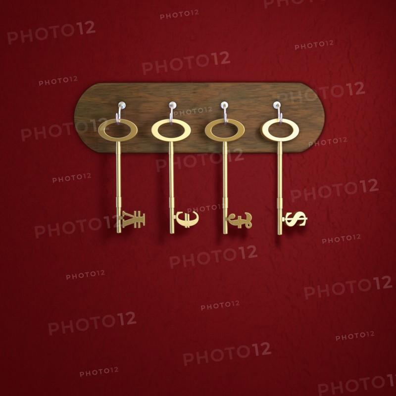 Keys with Yen, Euro, Pound Sterling and Dollar symbol hanging on red wall. Photo: Jon Boyes