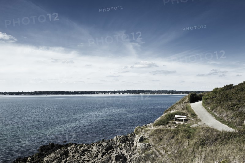 France, Brittany, Finistere Department, Bench, coastline and ocean. Photo: Jon Boyes