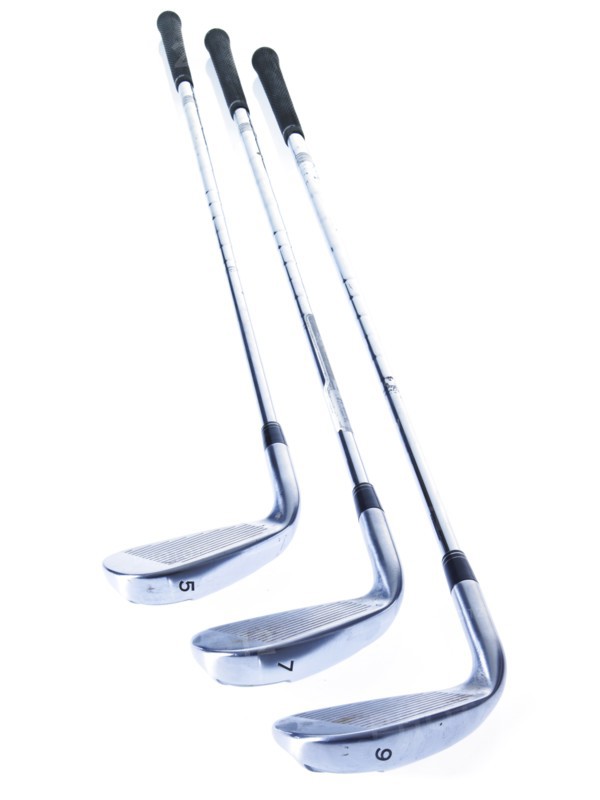 Three golf clubs on white background. Photo: David Arky