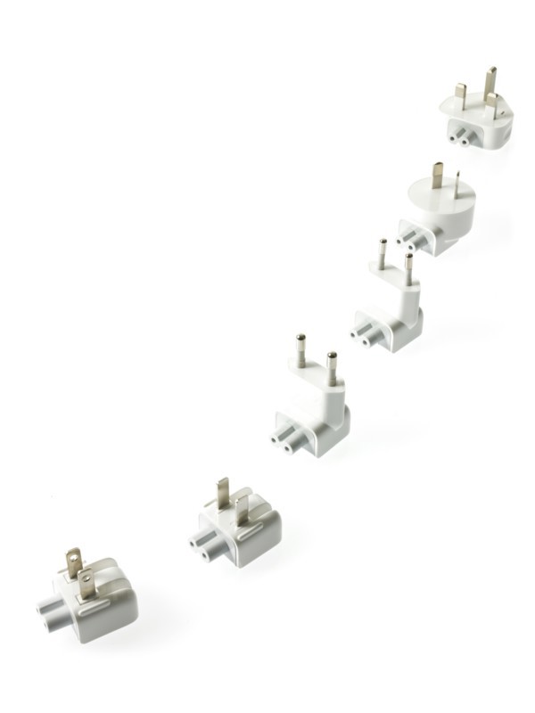 Row of plugs on white background. Photo : David Arky