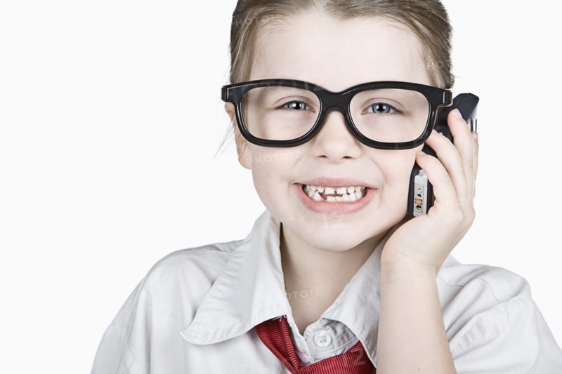 Studio portrait of girl (6-7) dressed-up as businesswoman. Photo: Justin Paget