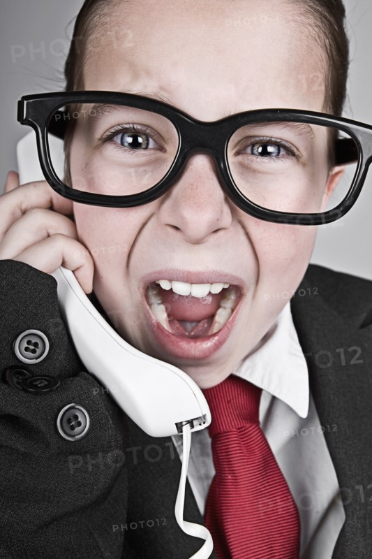 Studio portrait of girl (6-7) dressed-up as businesswoman. Photo : Justin Paget