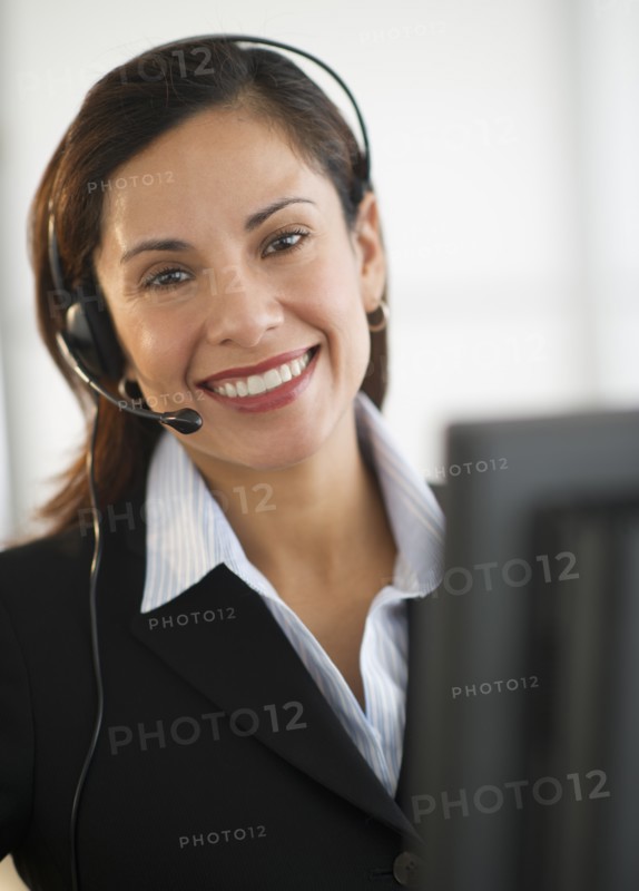 Smiling female customer service representative with headset.