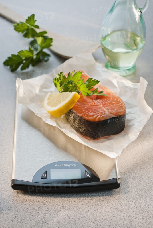 Slice of salmon on weight scale.