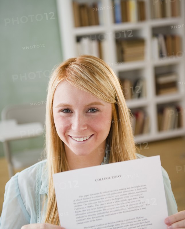 Female student showing essay. Photo : Jamie Grill Photography