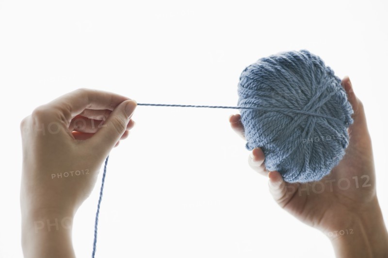 Studio shot of woman with ball of wool.