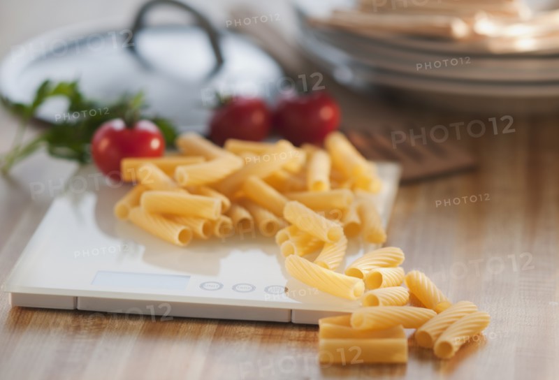 Raw pasta on weight scale.