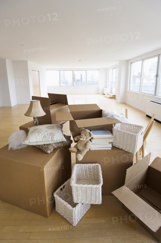 Boxes and decors stacked in room.