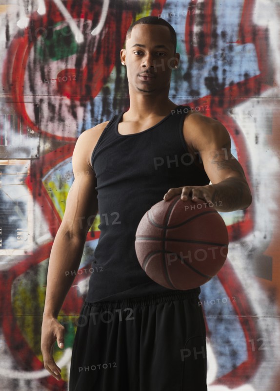 USA, Utah, Salt Lake City, portrait of basketball player in front of graffiti. Photo: Mike Kemp