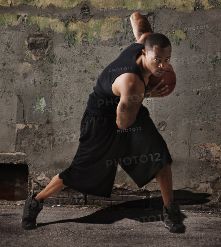USA, Utah, Salt Lake City, man playing basketball in front of wall. Photo: Mike Kemp