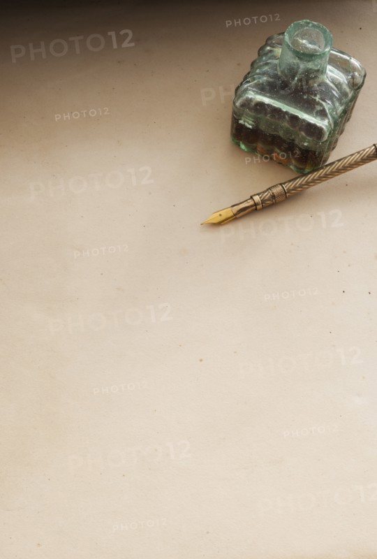 Close up antique ink well and pen.